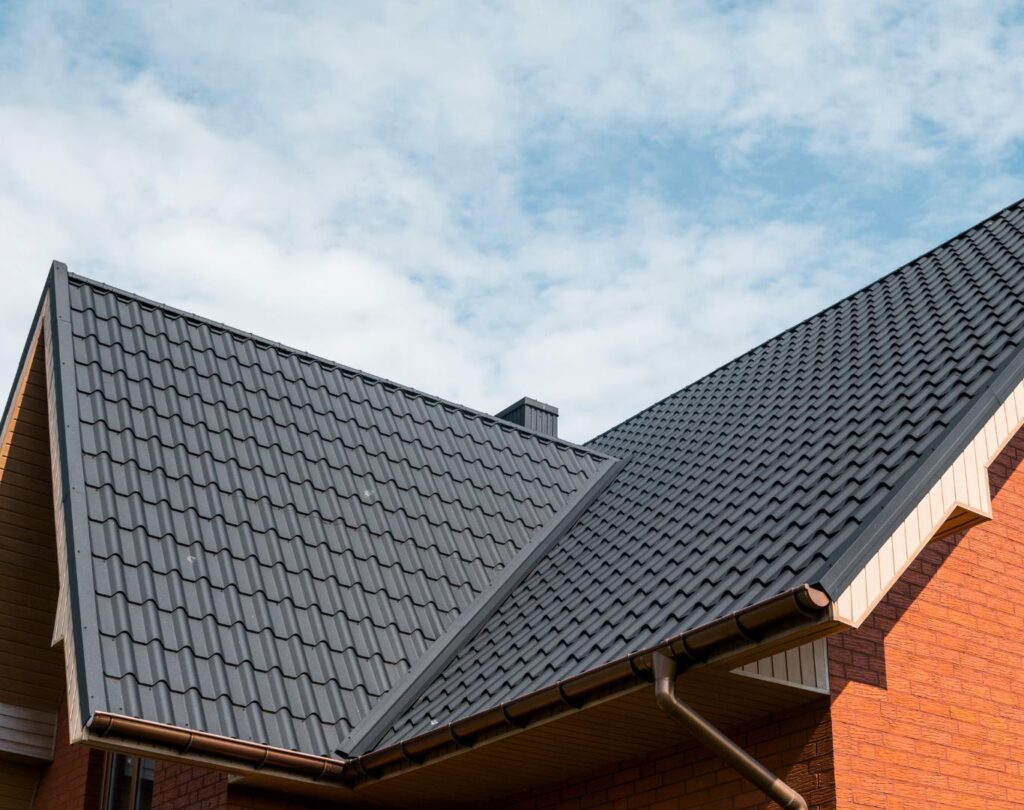 Professional contractors from a roofing company near me in Asheville, NC, replacing an old, worn-out roof