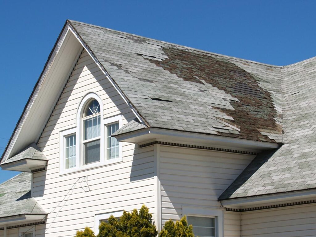 Reliable roof repair in Asheville, NC, fixing storm-damaged shingles on a residential roof