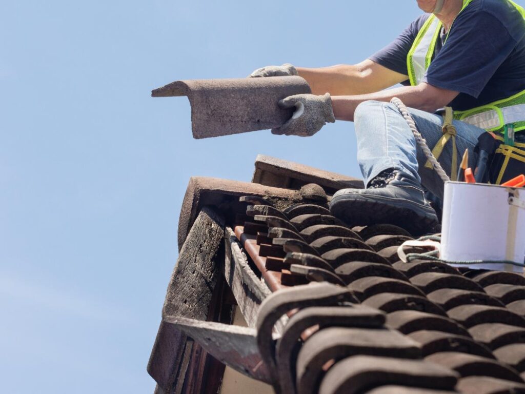 Roof repair in Lenoir, NC, addressing leaks around a residential chimney