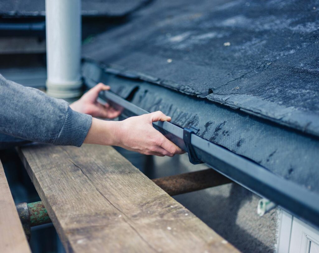 Local gutter company near me in Yadkinville, NC, installing seamless aluminum gutters